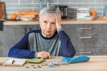 Senior woman counting money at home - obrazy, fototapety, plakaty