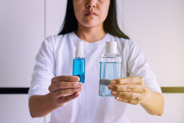 Woman hands holding sanitizer gel in pump bottle for hand hygiene coronavirus protection
