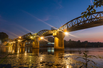 Naklejka na ściany i meble Landscape of Bridge River Kwai at Kanchanaburi, Thailand in night time. Is a famous place and a tourist destination