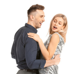 Happy dancing young couple on white background