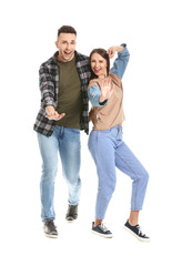 Fototapeta premium Young couple dancing against white background