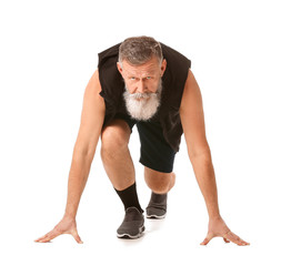 Elderly man in crouch start position on white background