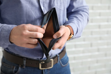 Man with empty purse, closeup