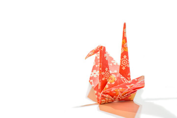 Colorful traditional Japanese origami crane in side view with space for text