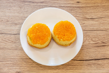 Shredded Egg Yolk Bread (Foi Tong Thai) in a white plate placed on a wooden table