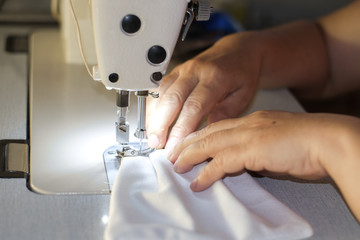 Handmade mask sewing from the fabric is used to prevent disease outbreaks with dust and viruses close-up.