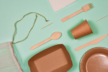 Zero waste, environmentally friendly, disposable, cardboard, paper utensils on a blue background. View from the top.