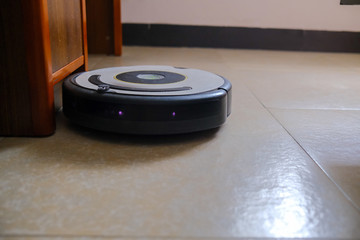 Sweeping robot working on floor at home