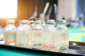 The vaccine vial with zeal cap use for testing CORONA virus (COVID-19) in laboratory. medical work place in cleaning room. Clinical trial evaluating vaccine designed to protect against coronavirus.