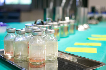 The vaccine vial with zeal cap use for testing CORONA virus (COVID-19) in laboratory. medical work place in cleaning room. Clinical trial evaluating vaccine designed to protect against coronavirus.