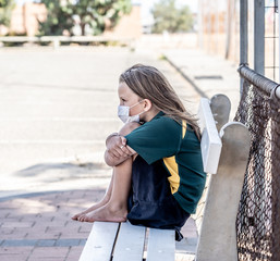 Schools closures Coronavirus lockdown. Bored and sad schoolgirl feeling depressed and lonely