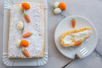 home made Easter sponge roll with carrots on a table