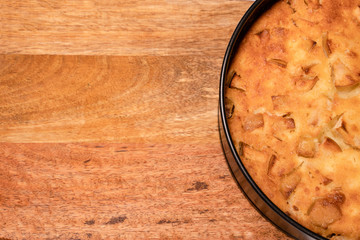 fragment of homemade cake in pan on wooden Board. 