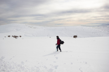 Fototapeta na wymiar climber man walking in the snow
