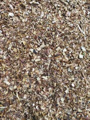 Wood sawdust background closeup. Sawdust floor texture. Top view. Sawdust texture, close-up background of brown sawdust. Use as a Background or Wallpaper. So Contrast or Grainy.