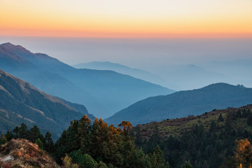 Stacked mountain ridges seen during golden hour of sunset from Poonhill Ghorepani Nepal