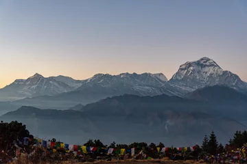 Papier Peint photo Dhaulagiri Majestic view of sunset sweeping through Dhaulagiri mountain range from Poon Hill, Ghorepani, Nepal
