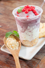 Crunchy cracker with low fat yogurt and red berry on wooden table, pink smoothie with cranberries, fruit shakes, Smoothie concept, Granola with yogurt, mini biscuits, cream and blueberry.