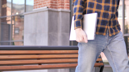 Redhead Beard Young Man Leaving Bench after Closing Laptop © stockbakers