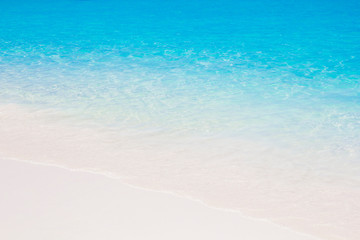 Fototapeta na wymiar blue sea water waves on white sand beach,Beautiful blue sea beach with white sand