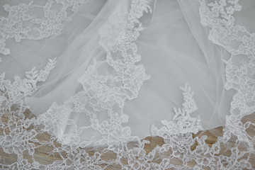 Texture, background, embroidered lace, delicate detail of a white wedding dress