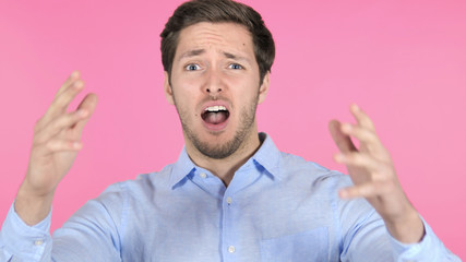 Man Upset by Results, Isolated on Pink Background