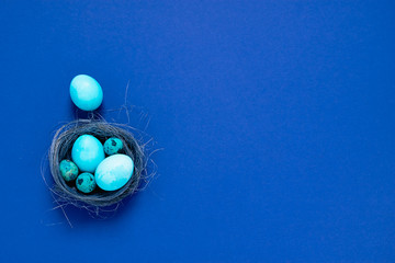 Happy easter concept. Festive spring composition blue small big eggs in a nest on a fashionable minimalistic background.