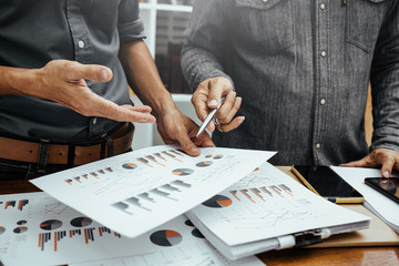 Business man analyzing financial graph and business report expense charts and profit.