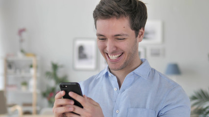 Excited Happy Man Using Smartphone, Chatting with Friends