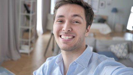 Young Blogger Smiling while Looking in Camera