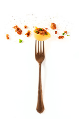 Italian pasta. A vintage fork with a conchiglie, minced meat, and parsley, sprinkled with black...