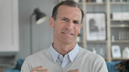 Middle Aged Man Upset by Loss while Working in Office