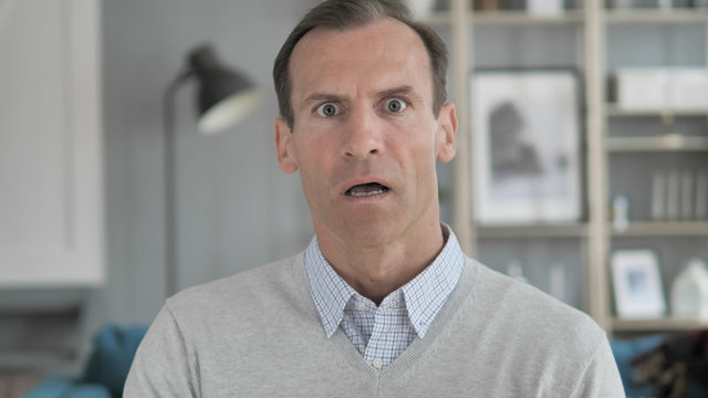 Portrait Of Amazed, Surprised Middle Aged Man Wondering