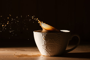 cup of coffee with steam on black background