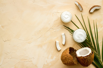 Fototapeta na wymiar Homemade coconut cream on beige background top-down frame copy space