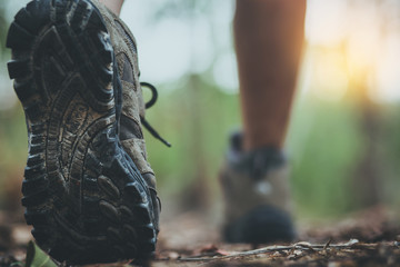Woman hiker sport shoes climbing.Close up image of woman running or walking outdoors. Low section view of legs in scenic nature.People body conscious and heathy lifestyle concept. - Powered by Adobe