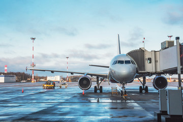 Passenger aircraft with boarding stairs, waiting for boarding passengers and baggage before the flight airport trip.