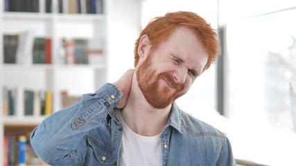 Young Casual Redhead Man with Neck Pain