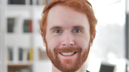 Smiling Face of Young Casual Redhead Man