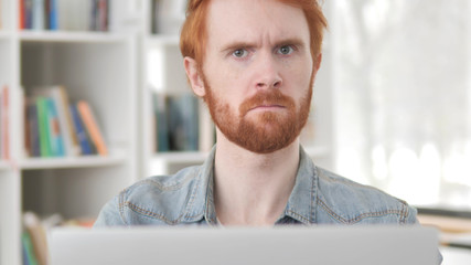 Young Casual Redhead Man Denying by Shaking Head, No