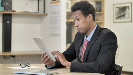 Young African Businessman Browsing on Tablet