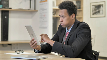 Young African Businessman Reacting to Loss on Tablet