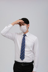 businessman man feeling sick, headache wearing protective mask against cold flu virus bacteria infection pollution