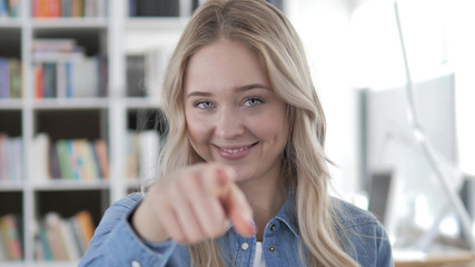 Young Blonde Woman Pointing with Finger