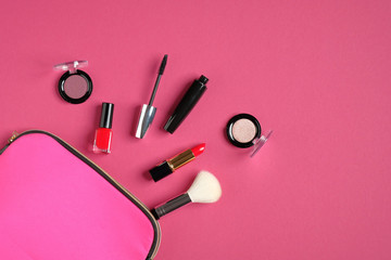 Obraz na płótnie Canvas Make-up products with cosmetic bag on pink background. Flat lay, top view. Beauty and fashion concept.