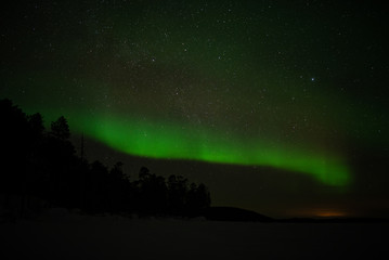 Fototapeta na wymiar aurora borealis at frozen sea in ivalo, finland.