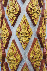 Golden Buddhist statues in a temple in an Asian country.