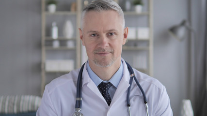 Portrait of Serious Doctor with Grey Hairs