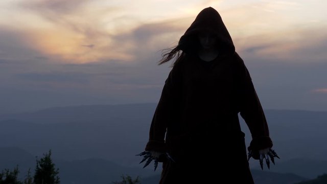 Epic fantasy scene of sorcerer standing on top of the hill