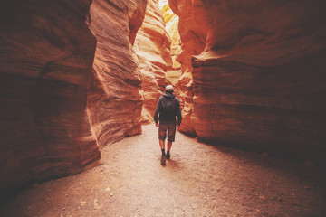 A man walking in canyon back to the camera. Red canyon, Eilat, Israel - obrazy, fototapety, plakaty